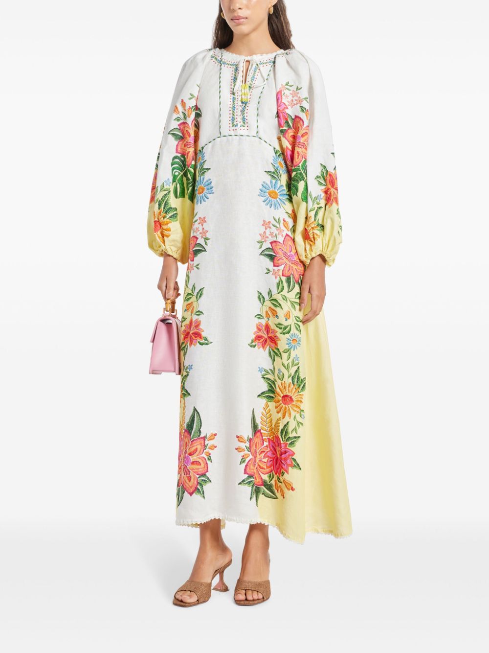 Introducing the Bloom Maxi Dress by FARM Rio. This off-white dress features a beautiful floral print and a unique tassel detail on the neckline. Made with lightweight and breathable linen, the maxi length and elastic cuffs add a playful touch to the elegant design. Complete your summer wardrobe with this must-have piece!