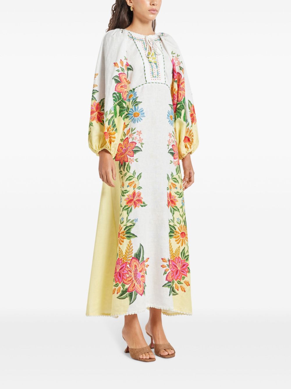 Introducing the Bloom Maxi Dress by FARM Rio. This off-white dress features a beautiful floral print and a unique tassel detail on the neckline. Made with lightweight and breathable linen, the maxi length and elastic cuffs add a playful touch to the elegant design. Complete your summer wardrobe with this must-have piece!