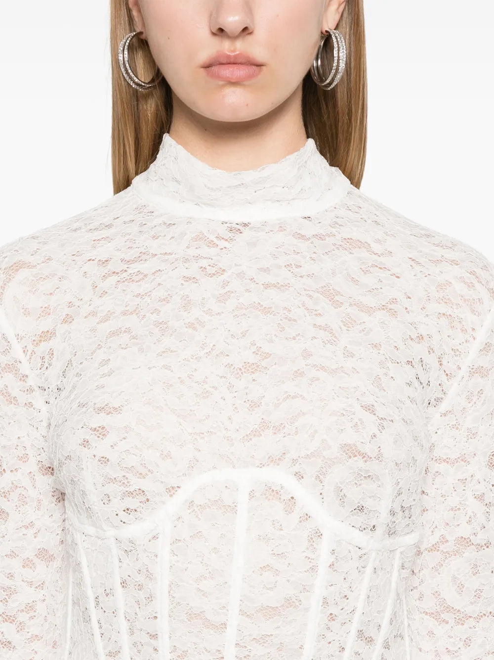 The Isadora Mini Dress in milk white blends delicate lace with a flirty, semi-sheer design. Featuring a stand-up collar, long sleeves, and a corset-style boned bodice, it flatters your figure while adding charm. The concealed rear hook and zip keep the look smooth, and the thigh-length straight hem gives a playful, yet elegant vibe perfect for any occasion.