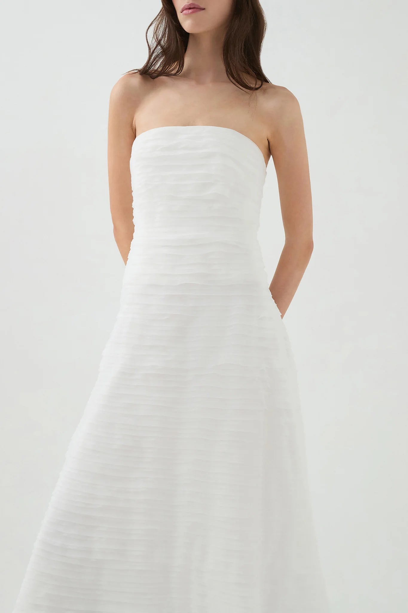 Elevate your style with the Soundscape Maxi Dress by Aje, designed to captivate every gaze. This strapless gown features a fitted bodice with internal boning for a flattering silhouette, paired with delicate raw edge frills adding a touch of effortless charm. The voluminous skirt flows gracefully, perfect for making a statement at any event. Fully lined and secured with a zip, hook, and eye closure, this dress combines comfort with elegance to ensure you look and feel stunning all day or night.