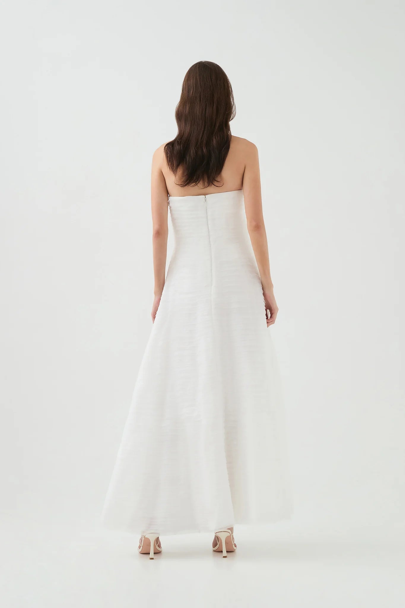 Elevate your style with the Soundscape Maxi Dress by Aje, designed to captivate every gaze. This strapless gown features a fitted bodice with internal boning for a flattering silhouette, paired with delicate raw edge frills adding a touch of effortless charm. The voluminous skirt flows gracefully, perfect for making a statement at any event. Fully lined and secured with a zip, hook, and eye closure, this dress combines comfort with elegance to ensure you look and feel stunning all day or night.