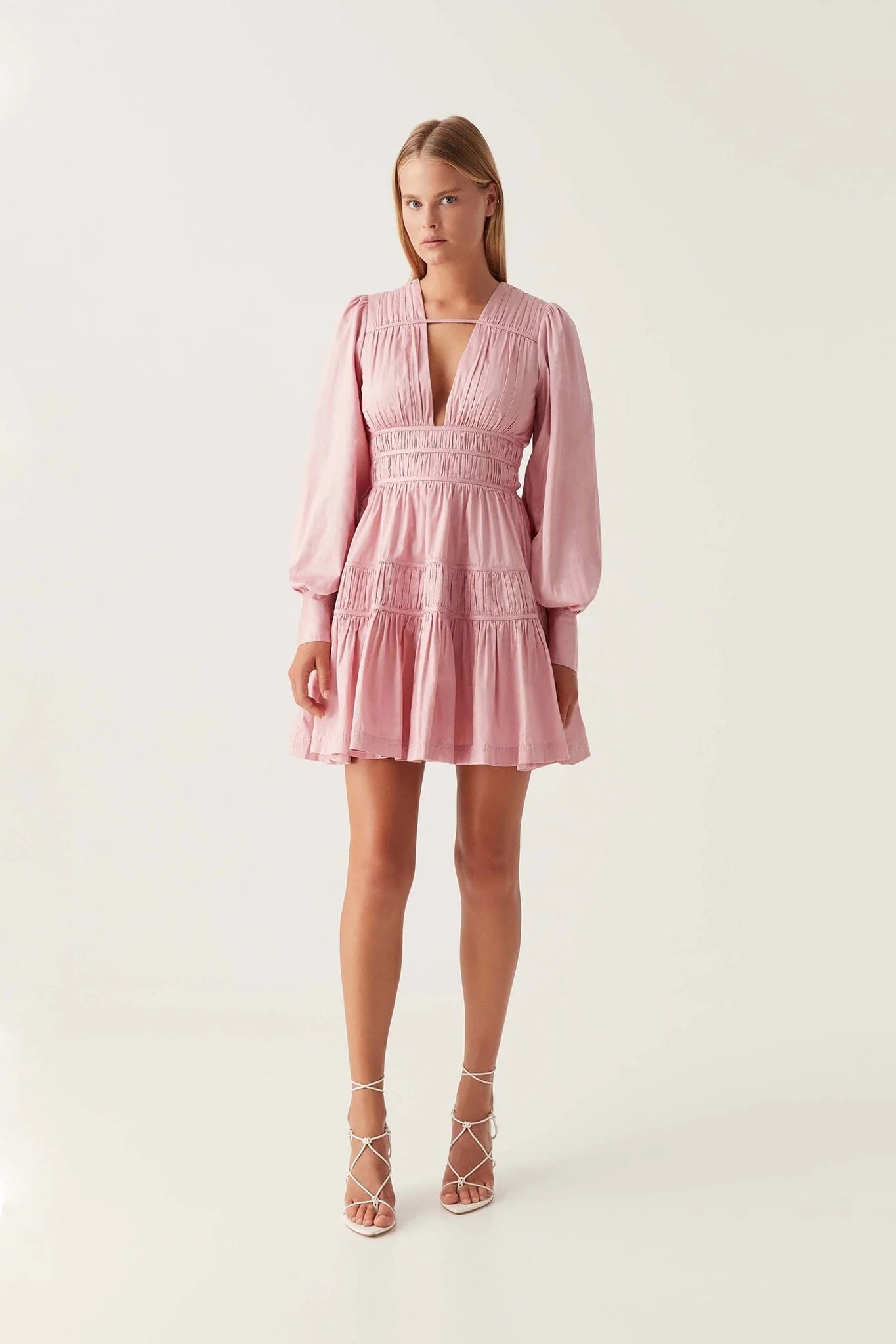 Elevate your wardrobe with the Fallingwater Mini Dress by Aje, crafted in an exclusive chalk pink shade. Featuring a deep neckline and long sleeves, this dress blends elegance with versatility. Perfect for any season, it transitions seamlessly from a girl's night out to weddings or formal dinners, ensuring you look effortlessly stunning wherever you go.