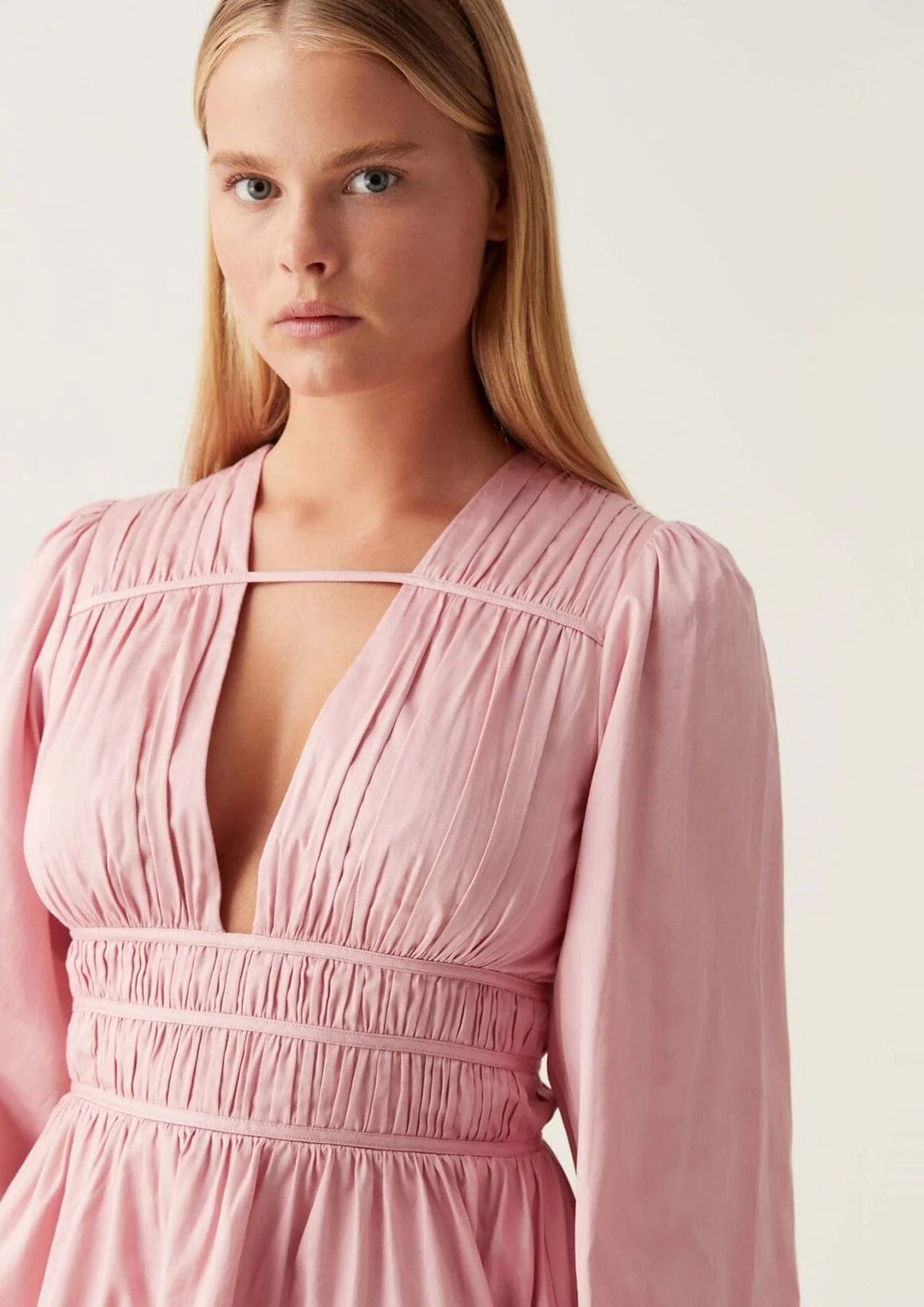 Elevate your wardrobe with the Fallingwater Mini Dress by Aje, crafted in an exclusive chalk pink shade. Featuring a deep neckline and long sleeves, this dress blends elegance with versatility. Perfect for any season, it transitions seamlessly from a girl's night out to weddings or formal dinners, ensuring you look effortlessly stunning wherever you go.