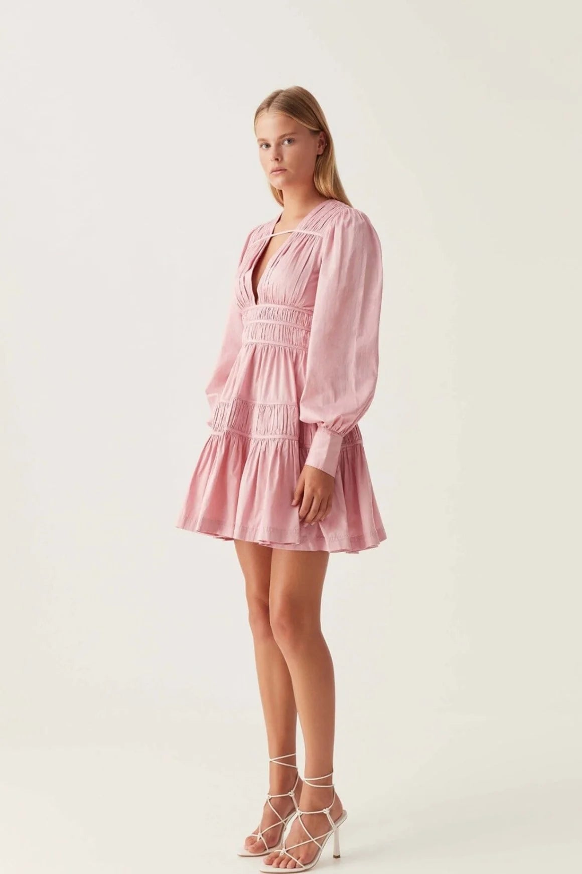 Elevate your wardrobe with the Fallingwater Mini Dress by Aje, crafted in an exclusive chalk pink shade. Featuring a deep neckline and long sleeves, this dress blends elegance with versatility. Perfect for any season, it transitions seamlessly from a girl's night out to weddings or formal dinners, ensuring you look effortlessly stunning wherever you go.