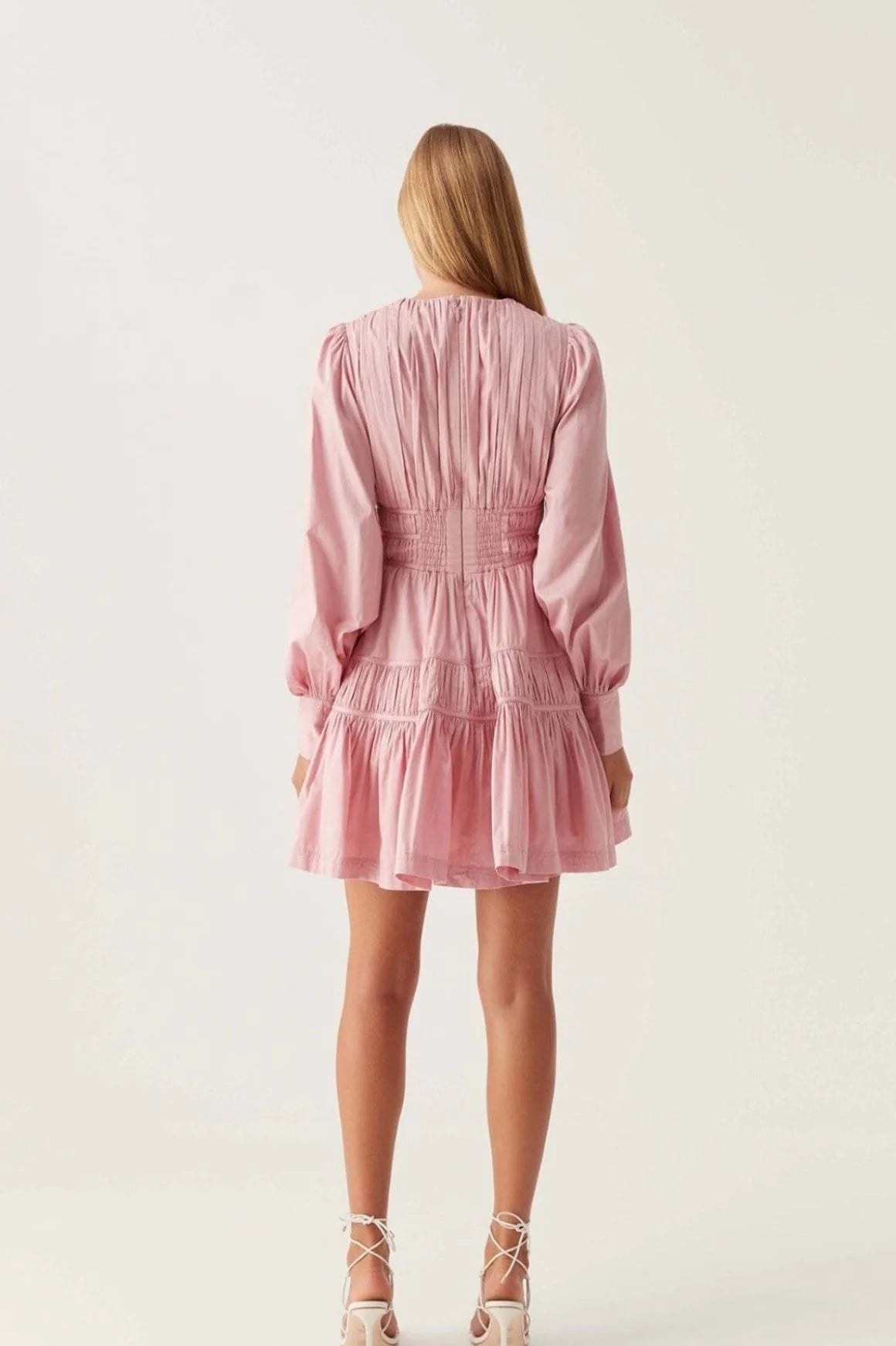 Elevate your wardrobe with the Fallingwater Mini Dress by Aje, crafted in an exclusive chalk pink shade. Featuring a deep neckline and long sleeves, this dress blends elegance with versatility. Perfect for any season, it transitions seamlessly from a girl's night out to weddings or formal dinners, ensuring you look effortlessly stunning wherever you go.