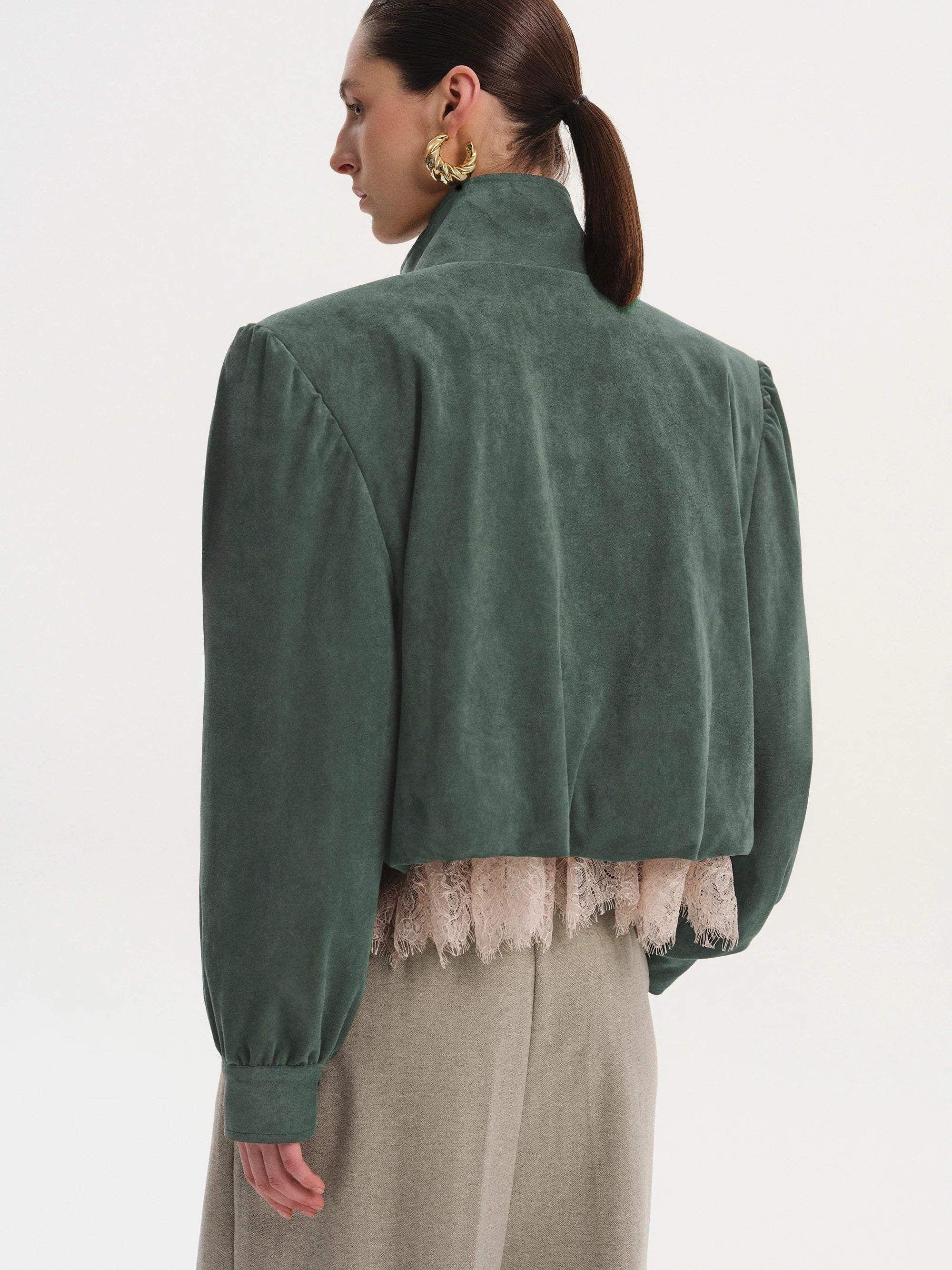 This Ruched Suede Jacket in Grey blends timeless style with contemporary flair. Featuring a boxy silhouette and padded shoulders, it exudes confidence, while the stand collar and gathered pleats add refined detail. The softly structured waistband creates a relaxed blouson effect, offering a polished look that’s both comfortable and stylish. Fully lined for all-day ease, this jacket effortlessly enhances any outfit with understated sophistication.