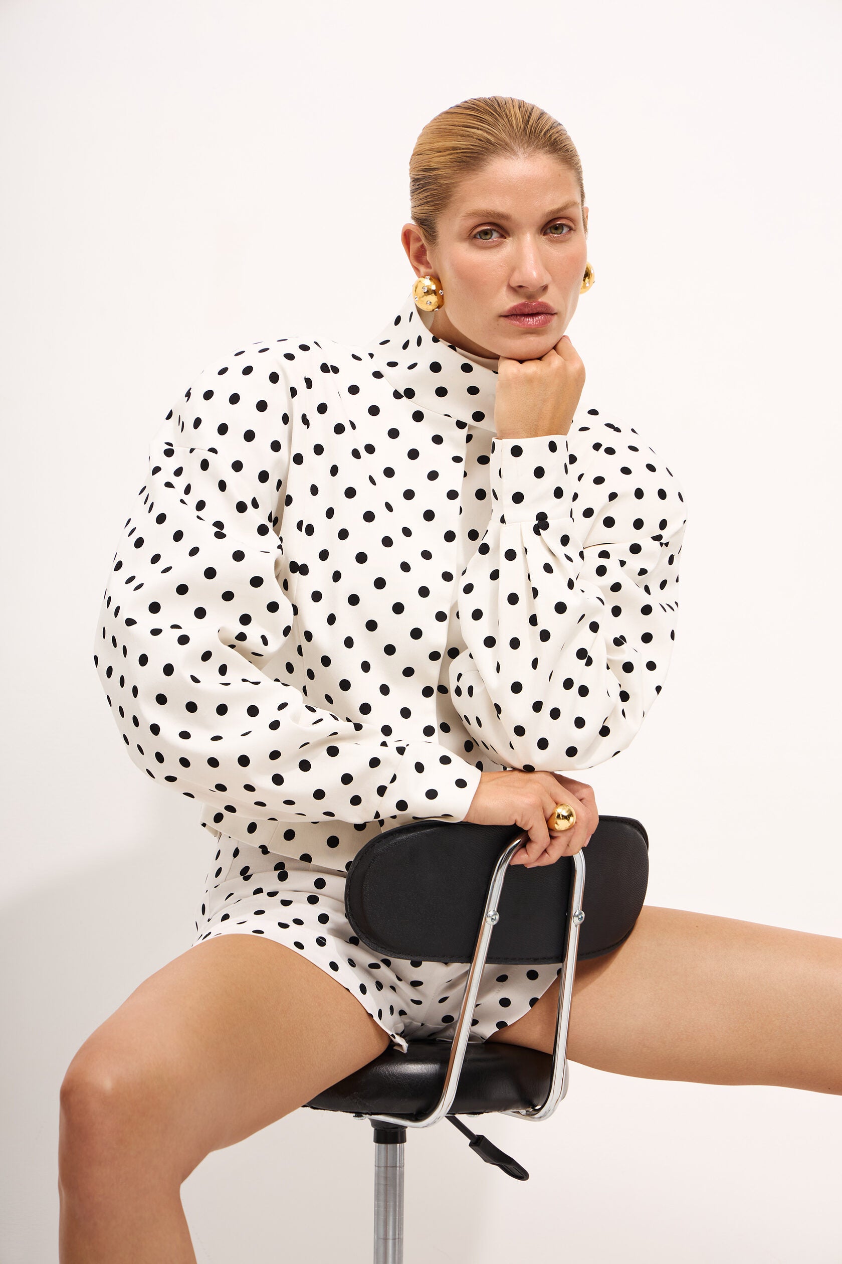 Elevate your casual wardrobe with this two-piece polka dot set featuring a standout stand collar jacket and coordinating shorts. The relaxed silhouette and long sleeves deliver effortless sophistication, while the playful dot pattern adds contemporary flair. Perfect for creating that coveted casual-chic aesthetic, this versatile ensemble transitions seamlessly from weekend errands to night-out moments. Embrace edgy streetwear style without compromising comfort.