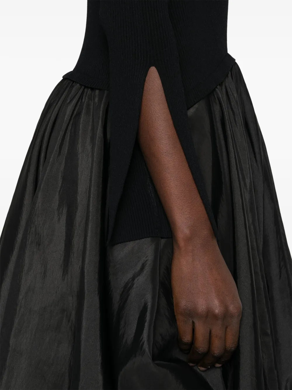 Step into charm with the Kenlie Midi Dress by Simkhai. This black beauty features a playful crew neck and split cuffs that add a flirty twist. The drop waist gives it a flattering silhouette, while the puffball hem dances with every step. Perfect for turning heads, this dress brings a fun and feminine vibe to any occasion.