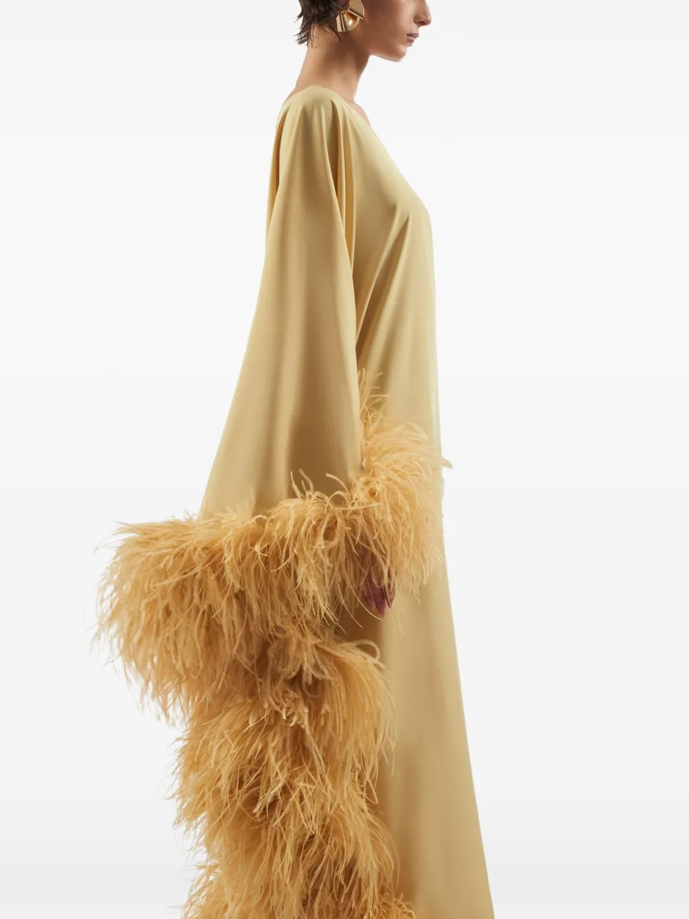 Elevate your style with the Ubud dress by Taller Marmo, crafted in Italy for a touch of refined elegance. This mustard yellow standout features a unique one-shoulder design with a single long sleeve, perfectly complemented by delicate feather detailing. The side zip fastening ensures a flawless fit, making it ideal for special occasions where you want to impress effortlessly.