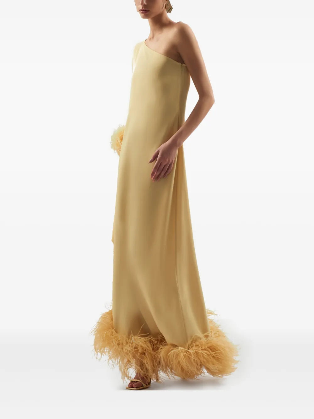 Elevate your style with the Ubud dress by Taller Marmo, crafted in Italy for a touch of refined elegance. This mustard yellow standout features a unique one-shoulder design with a single long sleeve, perfectly complemented by delicate feather detailing. The side zip fastening ensures a flawless fit, making it ideal for special occasions where you want to impress effortlessly.