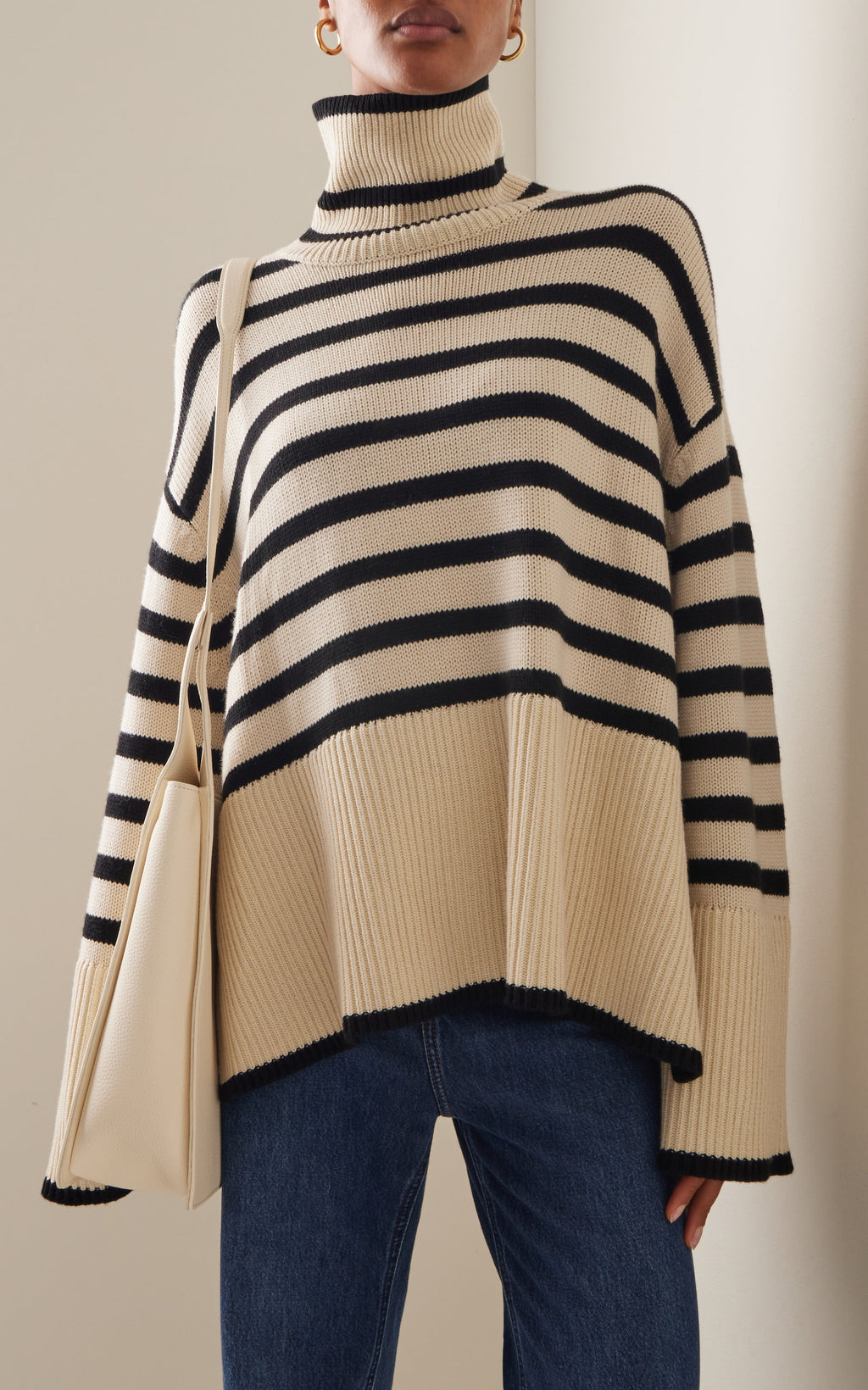 Elevate your wardrobe with the Signature Stripe Wool-Cotton Turtleneck Sweater by Totême. Blending cozy wool and breathable cotton, this sweater offers unmatched comfort and timeless style. Its clean lines and minimalist design reflect Stockholm's refined aesthetic, making it a versatile staple perfect for effortless layering. Inspired by vintage classics, this turtleneck channels modern Scandi-cool, providing a chic, everyday uniform that stands out with subtle sophistication.