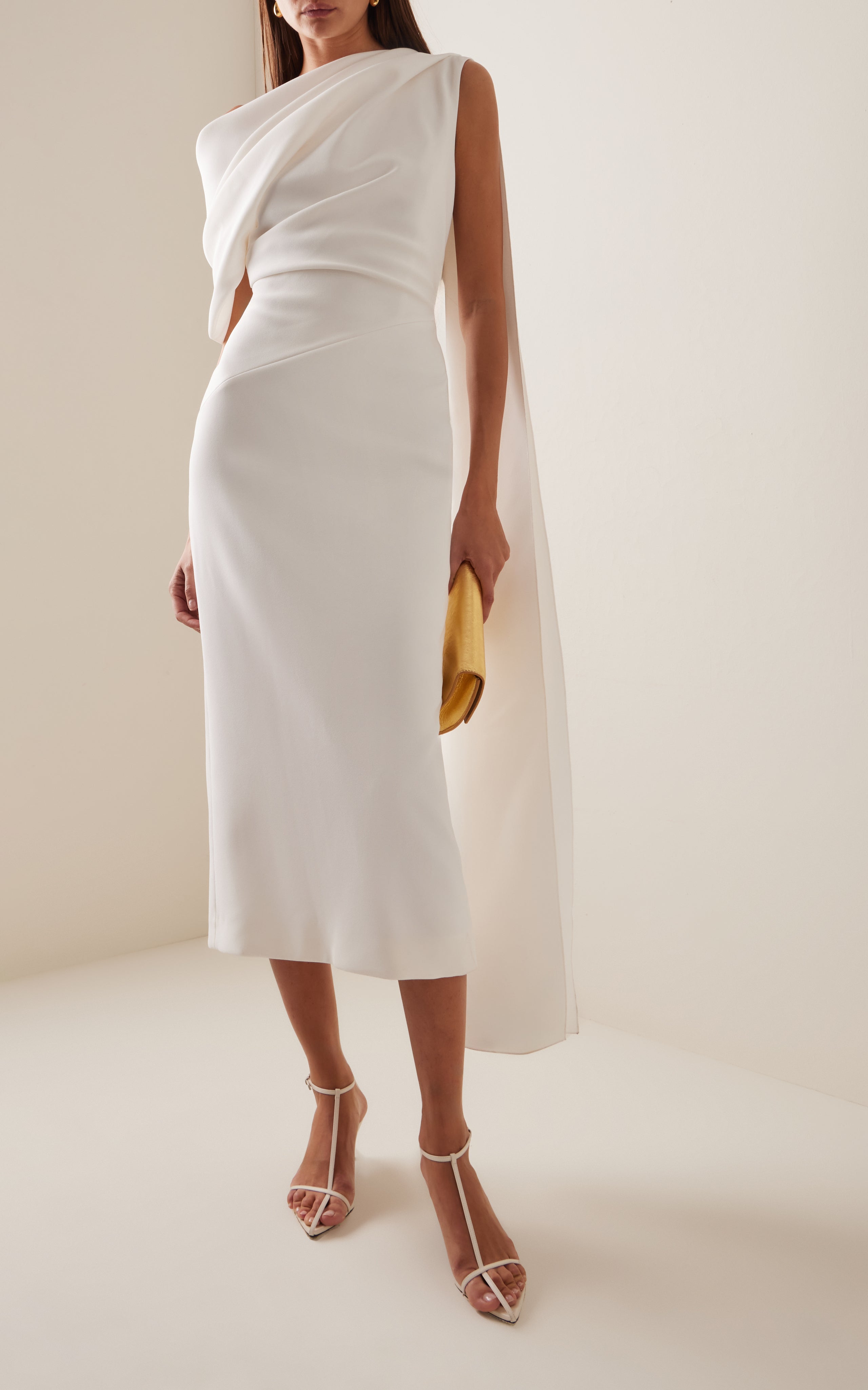 Experience the vibrant and modern aesthetic with the Maite Cape-Detailed Asymmetric Bonded Crepe Midi Dress by Roksanda. This dress features a single-shoulder cape and bold use of color, showcasing the label's expressive and dynamic use of fabrics. With its sculptural and structural design, the 'Maite' is sure to make a statement at any event.