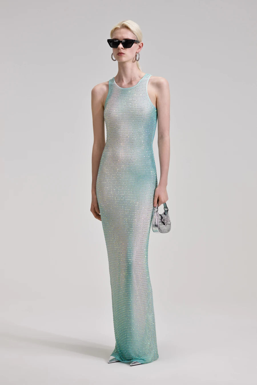 Experience pure opulence in the Green Contour Print Maxi Dress by Self Portrait. This shimmering dress features delicate crystals on gradient mesh, creating a mesmerizing effect that will turn heads. Elevate your style and make a statement with this luxurious and exclusive piece.