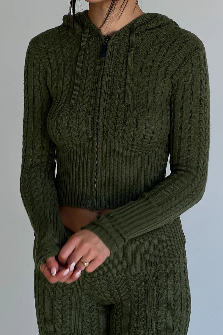 The Aimee Cloud Knit Hoodie by Frankies Bikinis is designed with the signature cable cloud knit fabric to provide body sculpting and warmth. It features vintage-inspired hardware and trim, ribbing on the cuffs and waist, a zip up front, and our new shade of Jade Green.