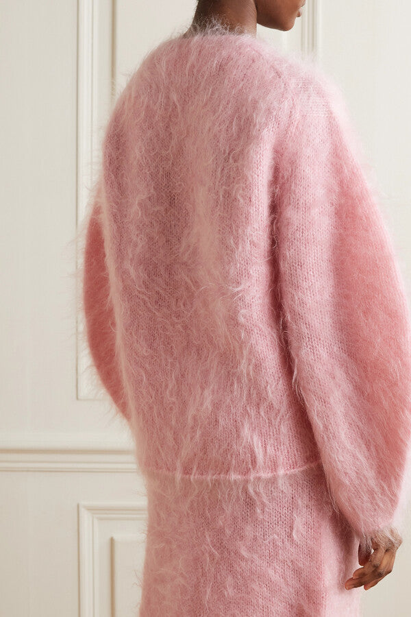 Experience luxurious comfort and style with the BY MALENE BIRGER Merino Wool Blend Set. The Hamie V-Neck Oversize Sweater boasts a cozy Mohair and Merino Wool blend in a feminine Bubble Pink color. Elevate your wardrobe and feel your best with this irresistible combination of quality and fashion.