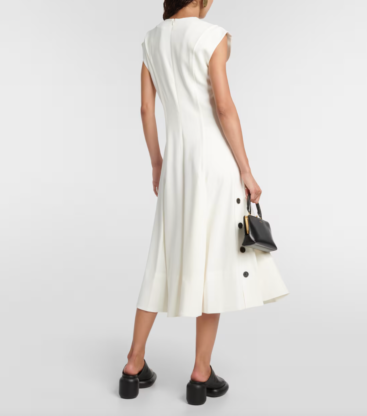 Elevate your wardrobe with this crepe midi dress, inspired by the timeless elegance of Proenza Schouler. Crafted from smooth crepe fabric, it boasts a flattering V-neckline and a fitted bodice that enhances your silhouette. The softly pleated A-line skirt adds gentle movement and grace, making it perfect for both special occasions and refined everyday wear. This dress combines effortless style with sophisticated charm, becoming an essential piece in any chic closet.