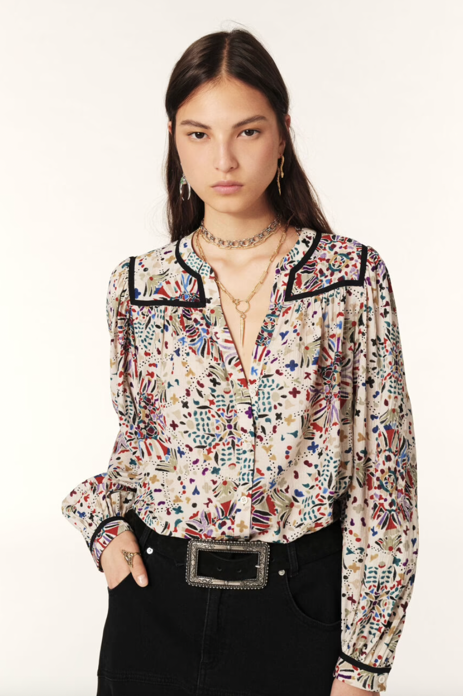 Indulge in the luxurious Faizae Blouse by ba&sh, a straight-cut shirt that highlights your figure with its fitted shoulders and loose, stretchy style. The small round collar and V-neck add a touch of sophistication, while the slightly puffed sleeves and contrasting bias details elevate the flowing fabric with a graphic motif. Perfect for the working girl with a taste for high fashion.