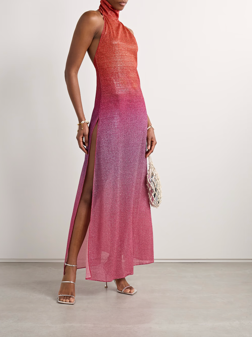 Elevate your evening with the Lumière maxi dress, designed to captivate in metallic ombrè stretch-knit fabric. Its halterneck silhouette beautifully frames your shoulders while the form-fitting stretch ensures a flattering fit that moves with you. Perfect for making a bold statement, this dress blends comfort and glamour effortlessly, turning heads from sunset to late night. Embrace your daring side with OSÉREE’s standout piece.