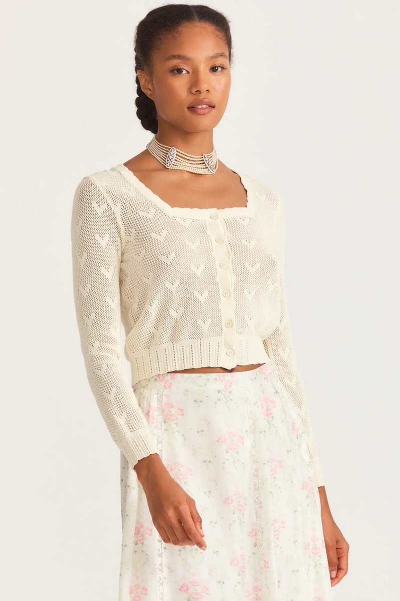 Upgrade your wardrobe with Cardigan Venice. This elegant knitted sweater comes in a vintage design with intricate embroidering and a chic cropped style. The long sleeves will keep you warm, while the unique hollow out details add a touch of sophistication. Perfect for adding a luxurious touch to any outfit.