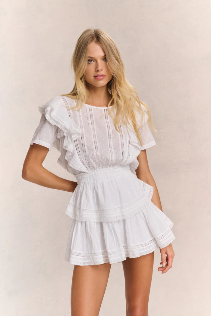 Elevate your style with the Natasha Heritage Mini Dress! The double ruffled flutter sleeves effortlessly accentuate the elasticated waist, while delicate lace trims add a touch of femininity. Perfect for any occasion, this dress exudes elegance and ease.