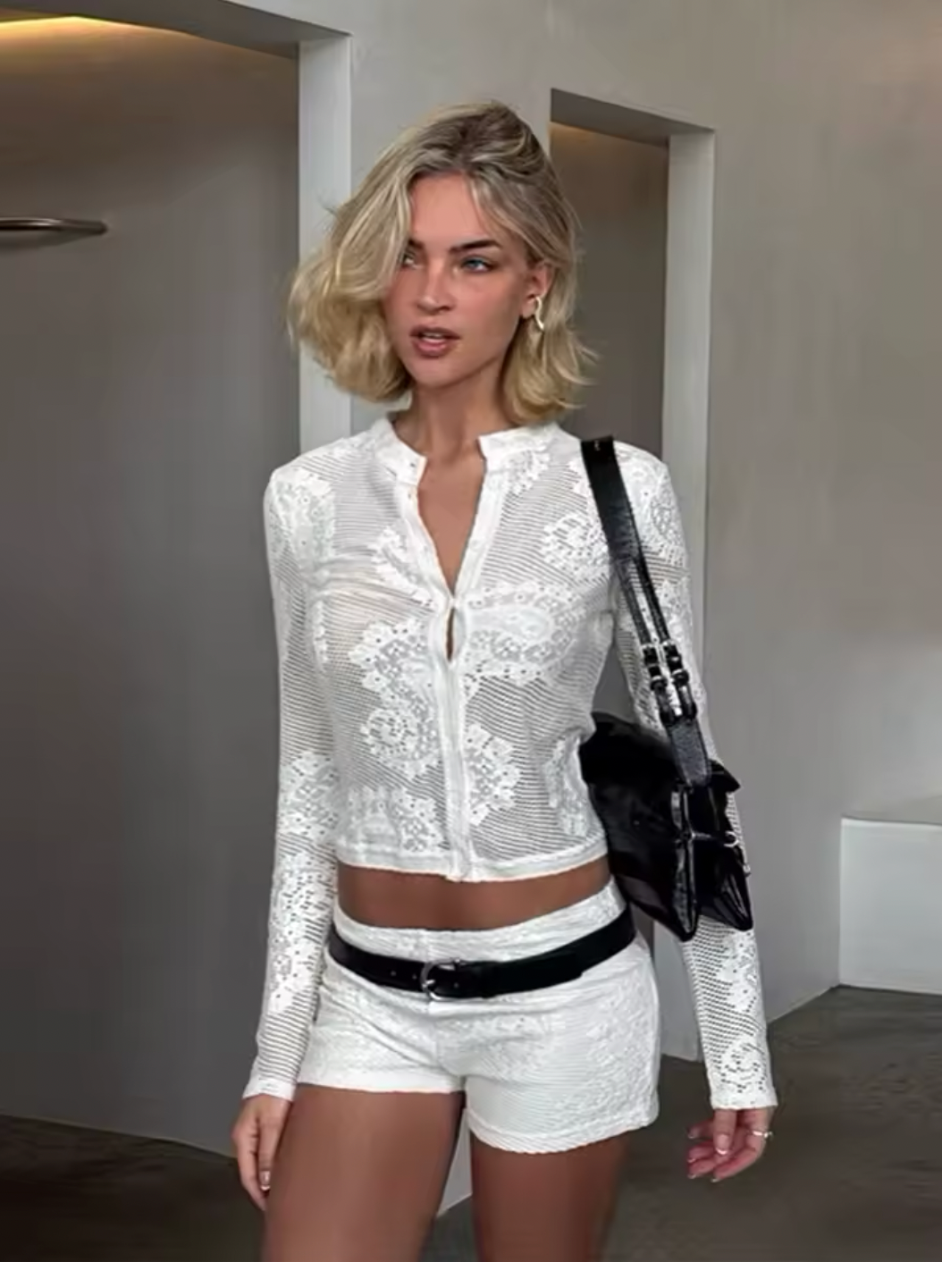 Elevate your wardrobe with the Dom Cardigan, a refined long-sleeve piece crafted for effortless elegance. Featuring a button-up front and a sleek neckline collar, its delicate scalloped trim and custom hand-drawn crochet lace detail add a touch of sophistication. Perfect for layering, this cardigan blends classic design with artisanal craftsmanship to enhance any outfit with subtle grace.