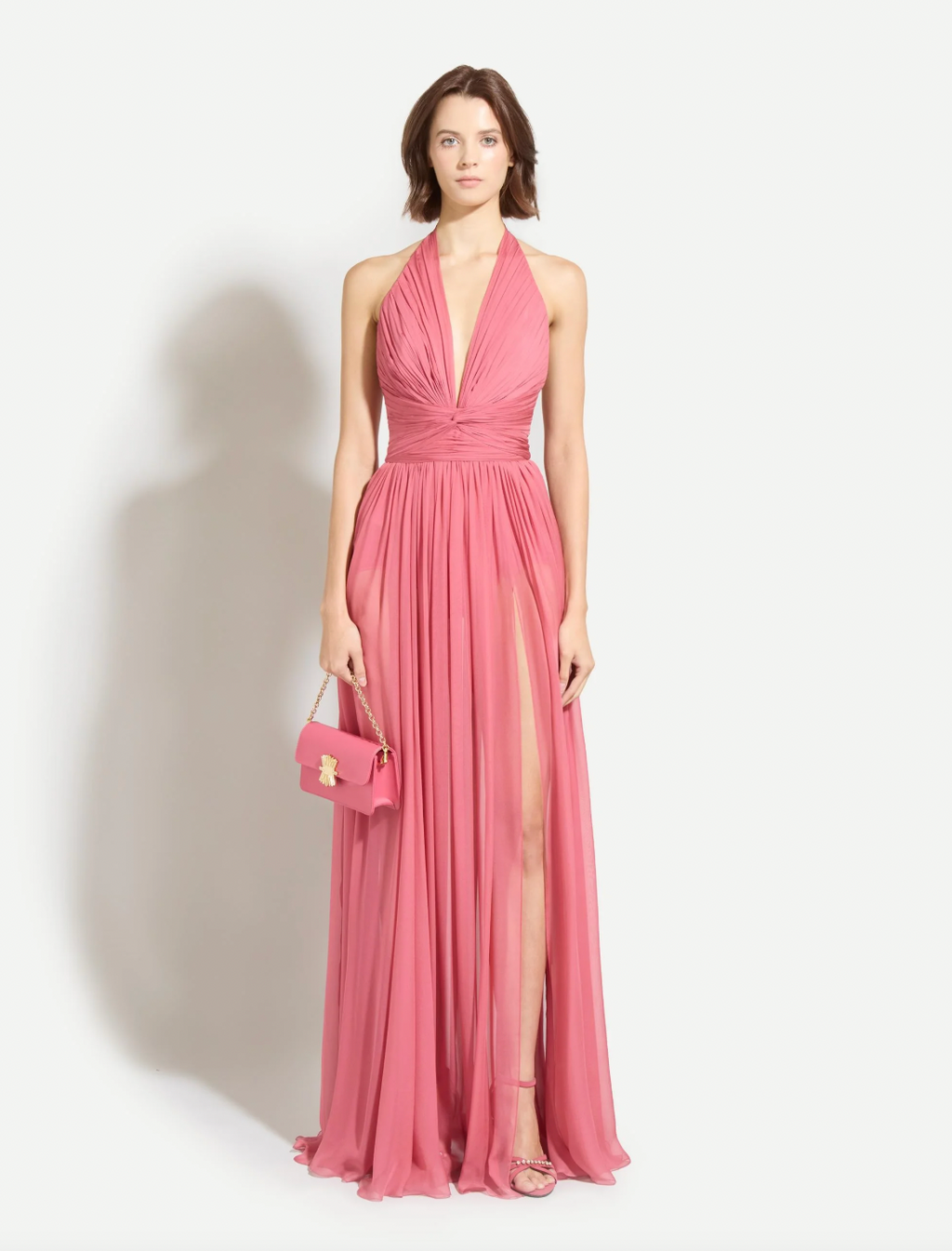 Captivate every room in this stunning rose red satin gown by Zuhair Murad, designed for those who dare to make a statement. The dramatic plunging V-neckline and daringly exposed back create an unforgettable silhouette that exudes confidence and sophistication. Expertly crafted with a concealed rear hook and smooth zip closure, this gown ensures a flawless, refined appearance from every angle. 