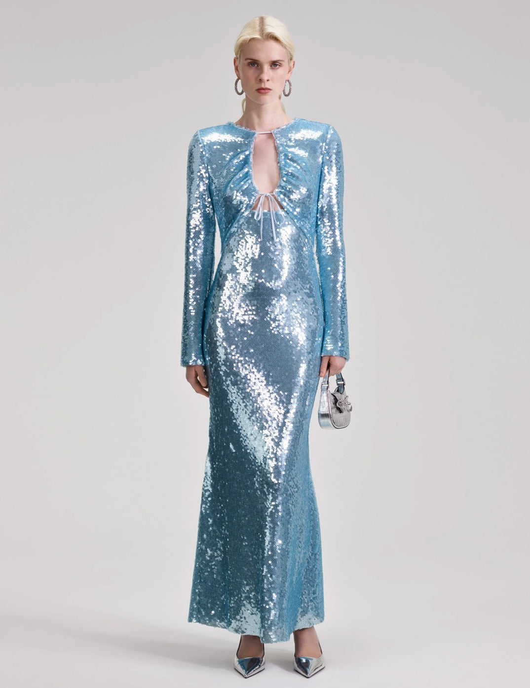 Indulge in glamour and shine with Self-Portrait's Sequin Maxi Dress. Crafted from a comfy woven fabric, this dress flatters with a shapely, slim fit and is adorned with sparkling sequins. Perfect for balls or disco nights, the dress creates a mesmerizing mirror ball effect. Let your inner diva shine!