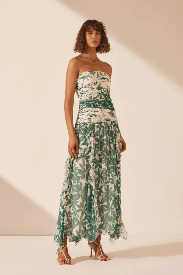 Unleash your inner flower child with the Marguerite Dress by Shona Joy! This stunning ruched maxi dress features a detachable strapless neckline and spliced contrast print, highlighting the exclusive Marguerite print. The lightweight semi-sheer chiffon adds a touch of elegance, while the boning in the bodice and invisible back zip provide a flattering fit. Perfect for any occasion, the gathered frill maxi length skirt will make you feel like a goddess.