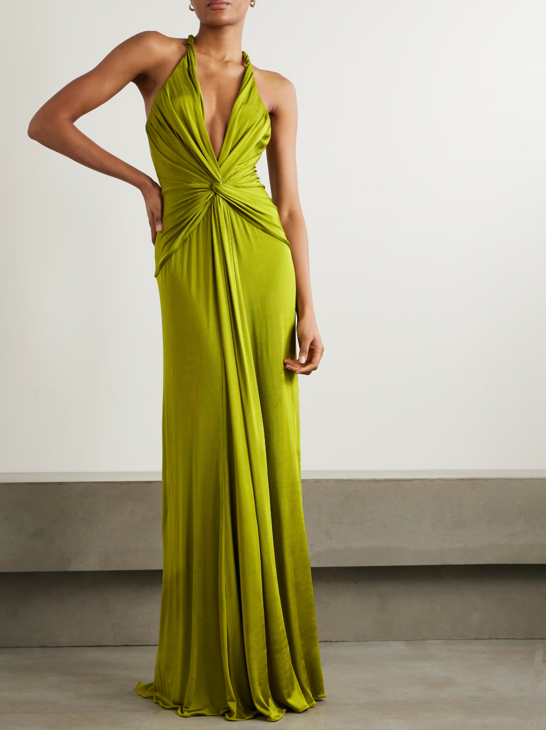 Elevate your evening in the Open-back Twist-front Jersey Gown by Tom Ford. Designed to impress, the plunging neckline and twisted front create beautiful drapes that flow to the floor. With eye-catching rolled shoulder straps and an alluring open back, this gown will make you the center of attention.