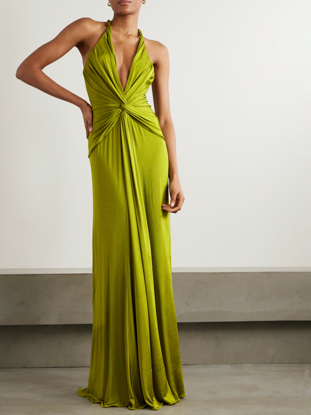 Elevate your evening in the Open-back Twist-front Jersey Gown by Tom Ford. Designed to impress, the plunging neckline and twisted front create beautiful drapes that flow to the floor. With eye-catching rolled shoulder straps and an alluring open back, this gown will make you the center of attention.