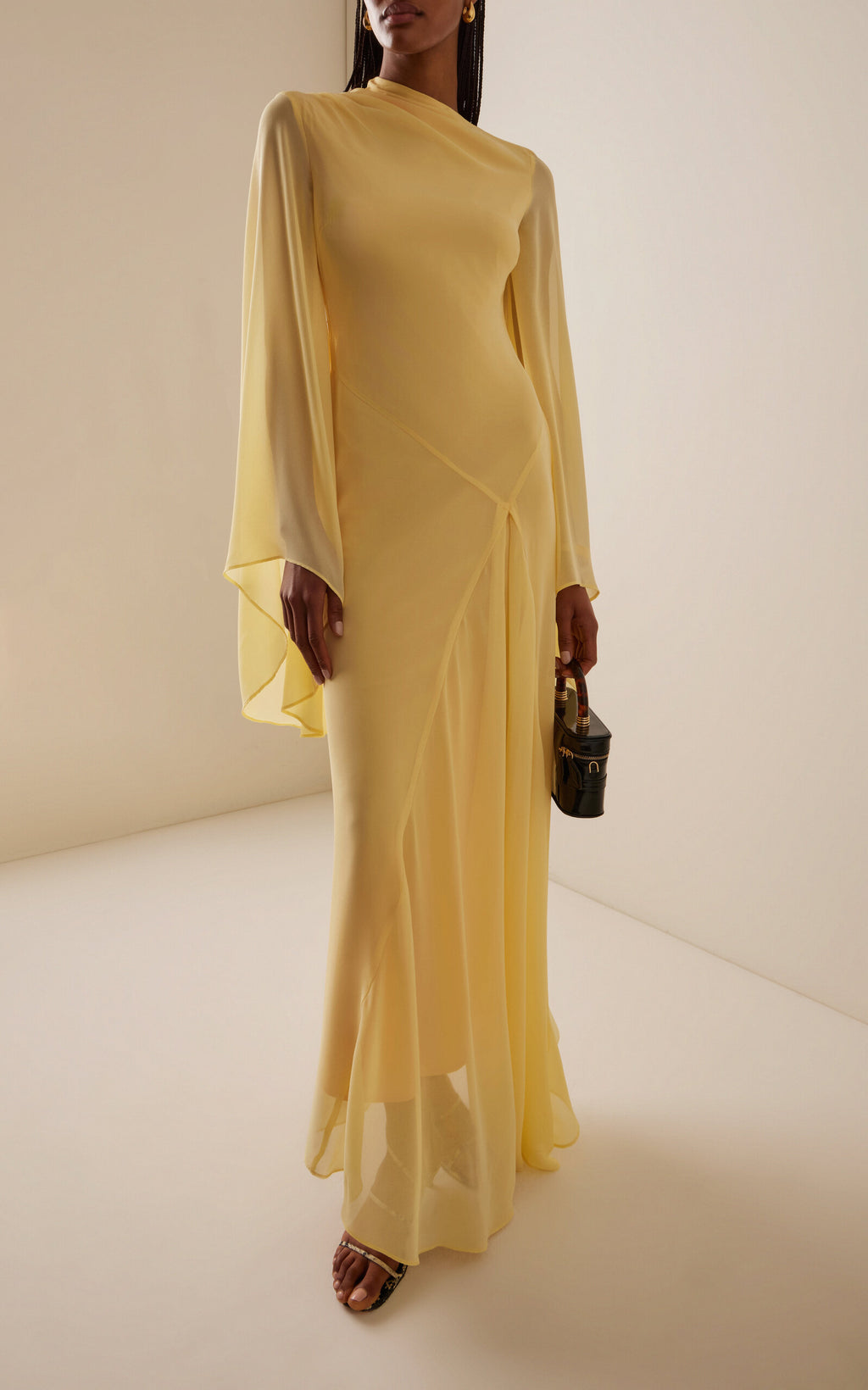 The Hausos Chiffon Maxi Dress by De La Vali features a graceful ankle-to-floor length with a dipped waist seam that enhances your natural silhouette. Its draped skirt with godet adds movement and flow, while the asymmetric neckline offers a unique touch. Long pagoda sleeves create a dramatic flare, combining elegance with a bold statement. Designed to make you feel confident and effortlessly empowered in every occasion.