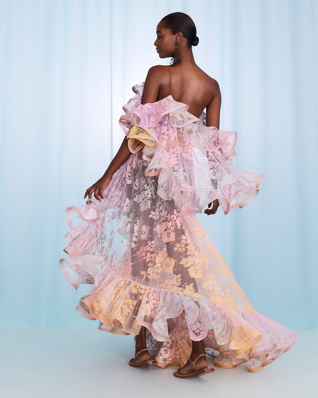 Step into the spotlight with the Dawning Ruffled Midi Dress in Lace from Zimmermann’s Spring 2025 Illumination Collection. This playful piece dazzles with asymmetric ruffles, a cape-style back, and a captivating side split flaunting a bold print. Perfect for turning heads at evening events, it pairs effortlessly with sleek heels and a chic clutch for a look that’s both dramatic and delightfully fun.