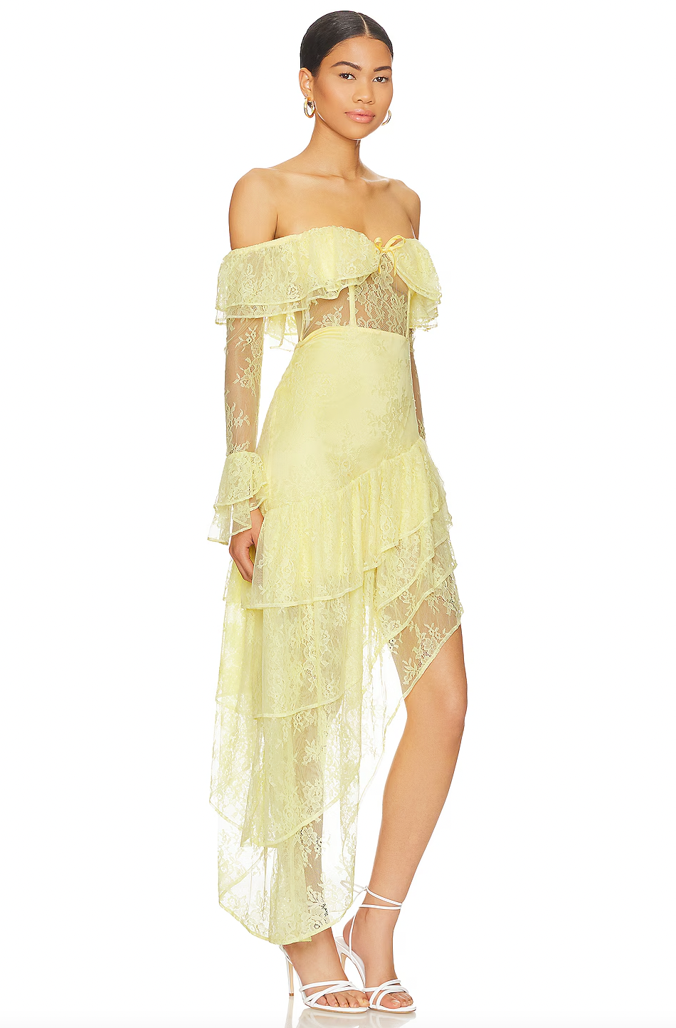 The Maddalena Gown by Majorelle combines timeless elegance with modern edge. This stunning piece features an off-shoulder silhouette with a structured boned bodice that flatters your figure, while delicate lace and playful ruffle details create movement and dimension. The asymmetric hem adds an unexpected twist that sets this gown apart, and the discreet back zipper ensures a seamless, polished look. Perfect for making an unforgettable entrance at any special occasion.