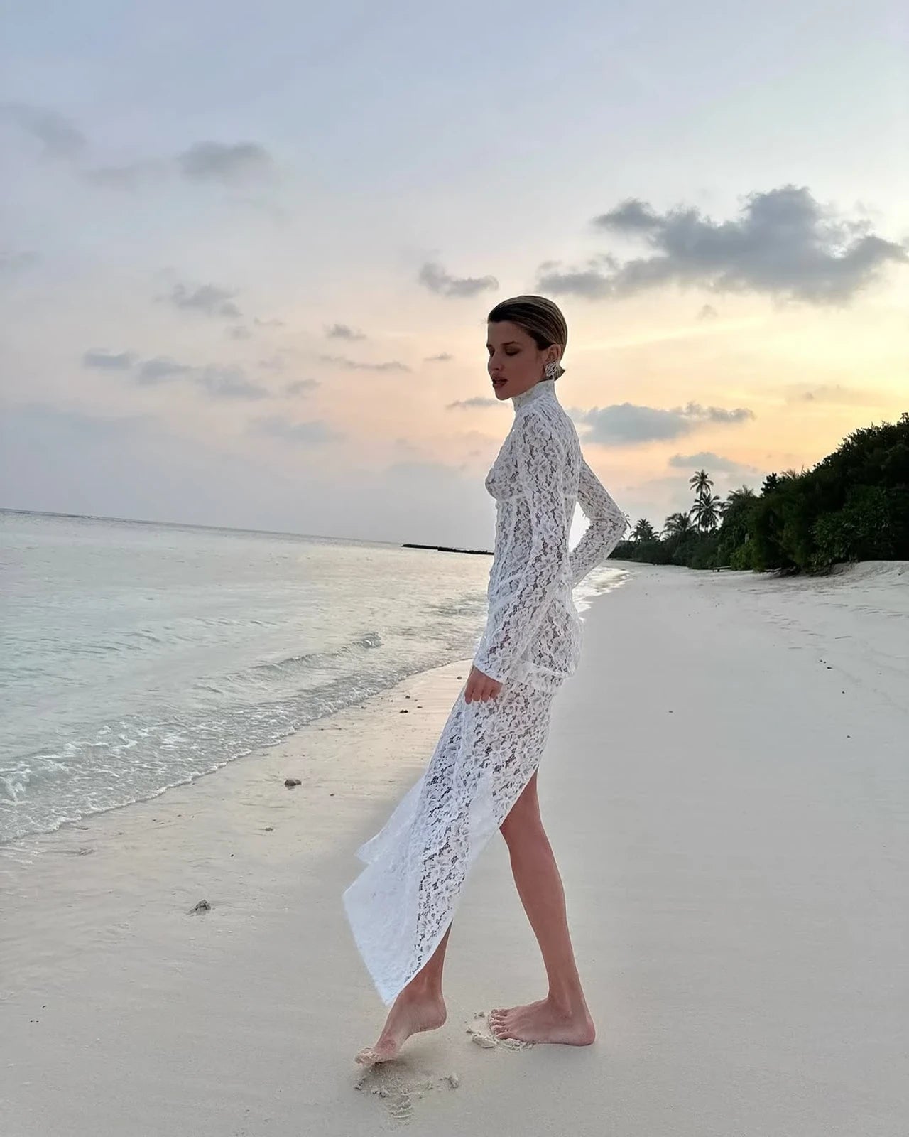 The Isadora gown by The New Arrivals Ilkyaz Ozel epitomizes refined elegance with its pristine white silhouette and architectural design. Featuring a structured boned bodice that sculpts the figure with precision, this statement piece showcases a sophisticated mock neck and innovative cuff zips for versatile styling. The concealed rear zip fastening ensures a seamless, polished finish. Perfect for those who appreciate couture-inspired details and timeless sophistication.