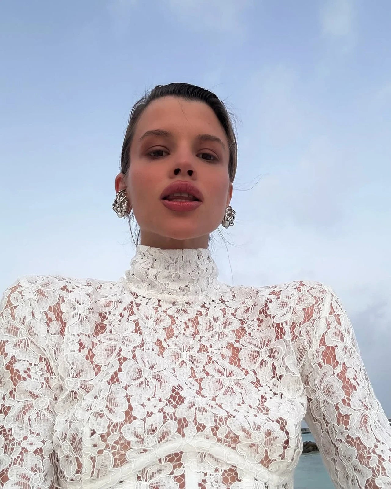 The Isadora gown by The New Arrivals Ilkyaz Ozel epitomizes refined elegance with its pristine white silhouette and architectural design. Featuring a structured boned bodice that sculpts the figure with precision, this statement piece showcases a sophisticated mock neck and innovative cuff zips for versatile styling. The concealed rear zip fastening ensures a seamless, polished finish. Perfect for those who appreciate couture-inspired details and timeless sophistication.