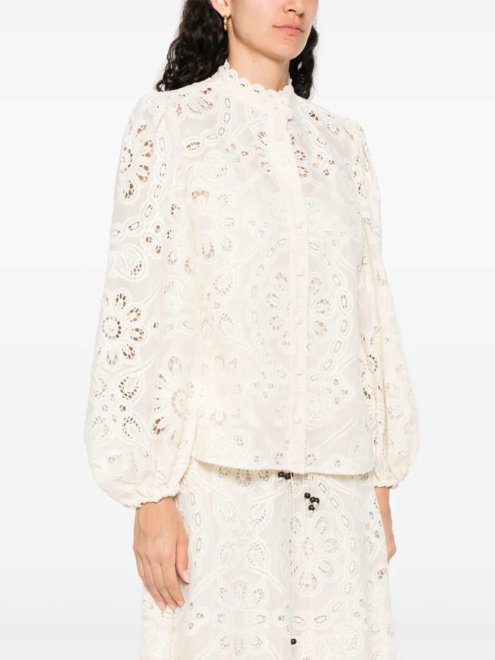 Elevate your wardrobe with this Zimmermann floral-embroidered shirt. In a versatile beige tone, it features delicate cut-out floral detailing that adds a touch of femininity and sophistication. The front button fastening ensures easy wear, while long sleeves with elasticated cuffs provide comfort and style. Perfect for any occasion, this shirt effortlessly combines elegance with everyday ease.