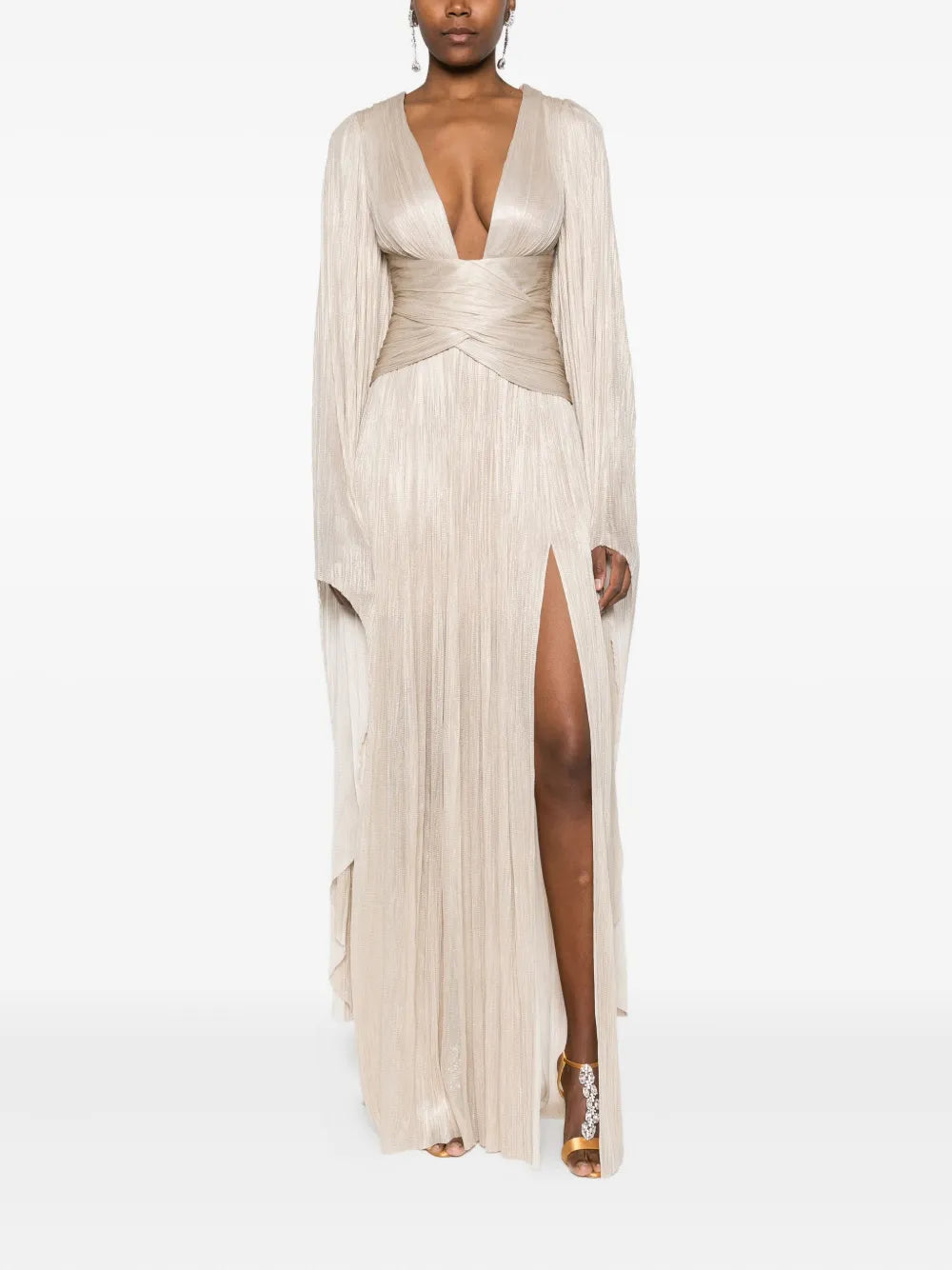 Elevate your wardrobe with the Aylin Maxi Dress by Maria Lucia Hohan, a sophisticated piece that seamlessly transitions from day to evening. This stunning beige gown features a flattering V-neckline and graceful long sleeves that provide elegant coverage. The expertly pleated design creates beautiful movement and dimension, while the signature wrap detail adds a refined touch of femininity. 