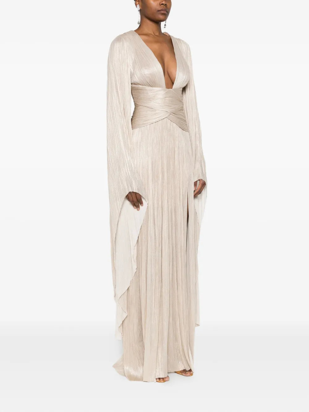 Elevate your wardrobe with the Aylin Maxi Dress by Maria Lucia Hohan, a sophisticated piece that seamlessly transitions from day to evening. This stunning beige gown features a flattering V-neckline and graceful long sleeves that provide elegant coverage. The expertly pleated design creates beautiful movement and dimension, while the signature wrap detail adds a refined touch of femininity. 