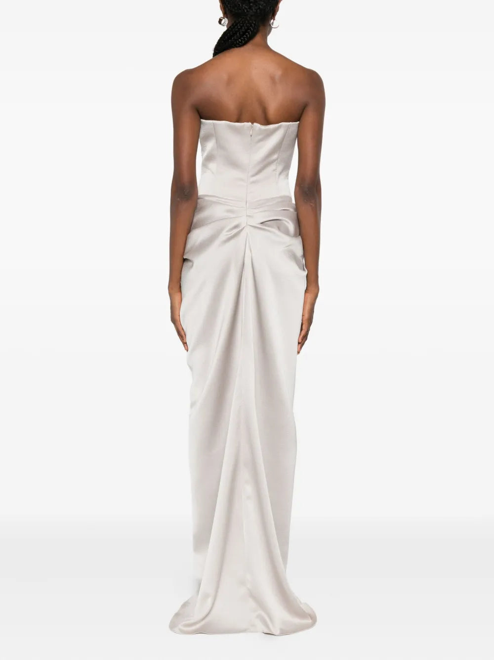 The Fabiana dress by M.Marquise is an imported evening gown that commands attention. This strapless masterpiece features elegant draped detailing and cascades to a dramatic floor length, creating an effortlessly sophisticated silhouette. Shimmering silver-tone crystal embellishments catch the light with every movement, adding glamorous sparkle to your most memorable moments. Perfect for galas, weddings, or upscale celebrations where timeless elegance matters.