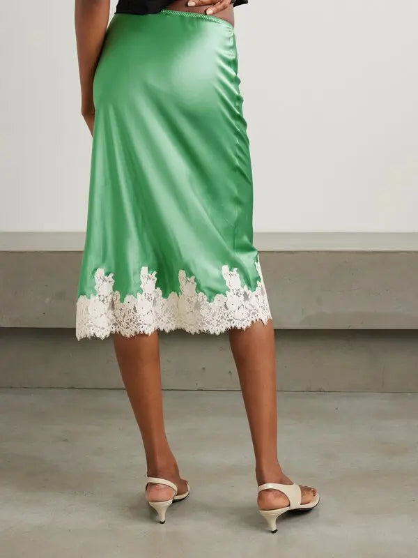 Elevate your wardrobe with the Elowena Lace-Trimmed Silk Midi Skirt from DÔEN. Crafted from luxurious silk and expertly cut on the bias, this slip-style skirt gracefully hugs your silhouette while offering a flawless drape. The delicate, hand-cut lace along the hem adds a refined, feminine touch, making it perfect for both elegant occasions and everyday sophistication. Embrace effortless style and timeless beauty with this captivating midi skirt.