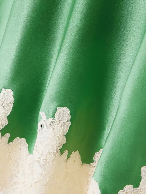 Elevate your wardrobe with the Elowena Lace-Trimmed Silk Midi Skirt from DÔEN. Crafted from luxurious silk and expertly cut on the bias, this slip-style skirt gracefully hugs your silhouette while offering a flawless drape. The delicate, hand-cut lace along the hem adds a refined, feminine touch, making it perfect for both elegant occasions and everyday sophistication. Embrace effortless style and timeless beauty with this captivating midi skirt.