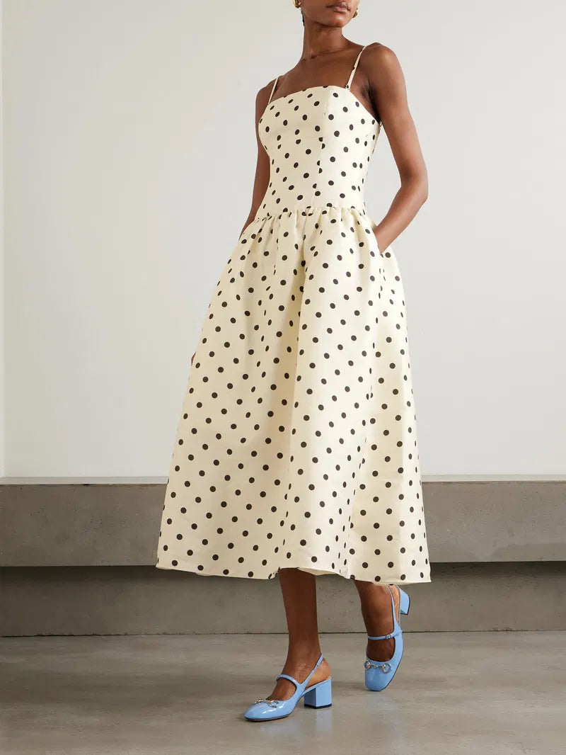Embrace timeless elegance with this Polka-dot taffeta midi dress inspired by classic 1950s fashion. The luxurious taffeta fabric shines subtly, while the structured bodice and gathered waist beautifully highlight a full, flattering skirt. Perfect for making a graceful statement, pair it with point-toe pumps to complete your vintage-chic look.