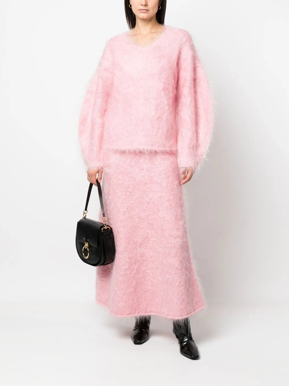 Experience luxurious comfort and style with the BY MALENE BIRGER Merino Wool Blend Set. The Hamie V-Neck Oversize Sweater boasts a cozy Mohair and Merino Wool blend in a feminine Bubble Pink color. Elevate your wardrobe and feel your best with this irresistible combination of quality and fashion.