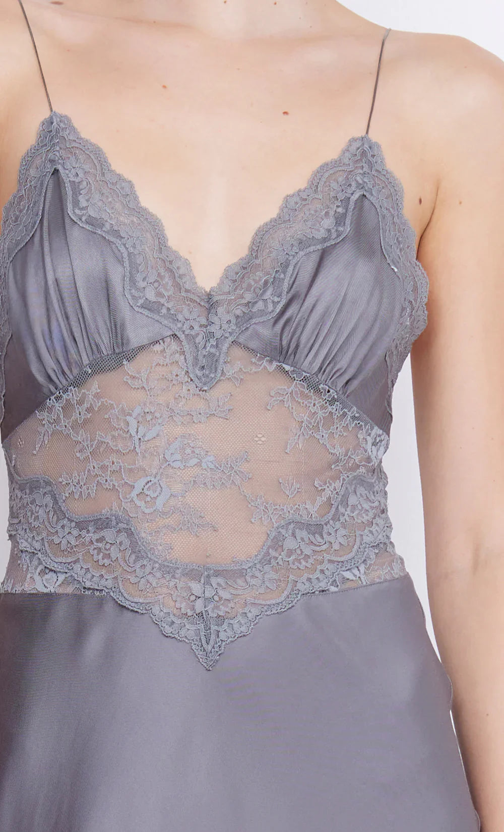 The Amoras Gown by BEC + BRIDGE combines elegance and allure with its V-neckline and flowing maxi silhouette. Crafted with a bias-cut skirt for a flattering fit, this dress features stretch lace that delicately reveals the midsection, adding a subtle hint of sophistication. The gathered bust cups and lace-trimmed neckline enhance its feminine charm, making it the perfect choice for unforgettable events where you want to stand out.