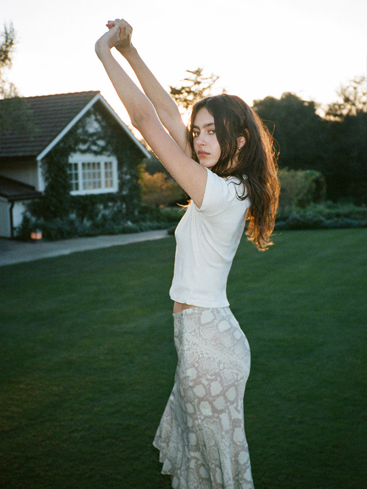 Experience the flirty and feminine charm of The Carmen in Absinthe by Realisation Par. This modern skirt features a flattering silhouette and fluted hemline that adds movement to every step. Perfect for any occasion, pair it with a fitted knit or crisp white tee for a versatile and effortless look. Indulge in classic charm with a touch of modern sophistication.