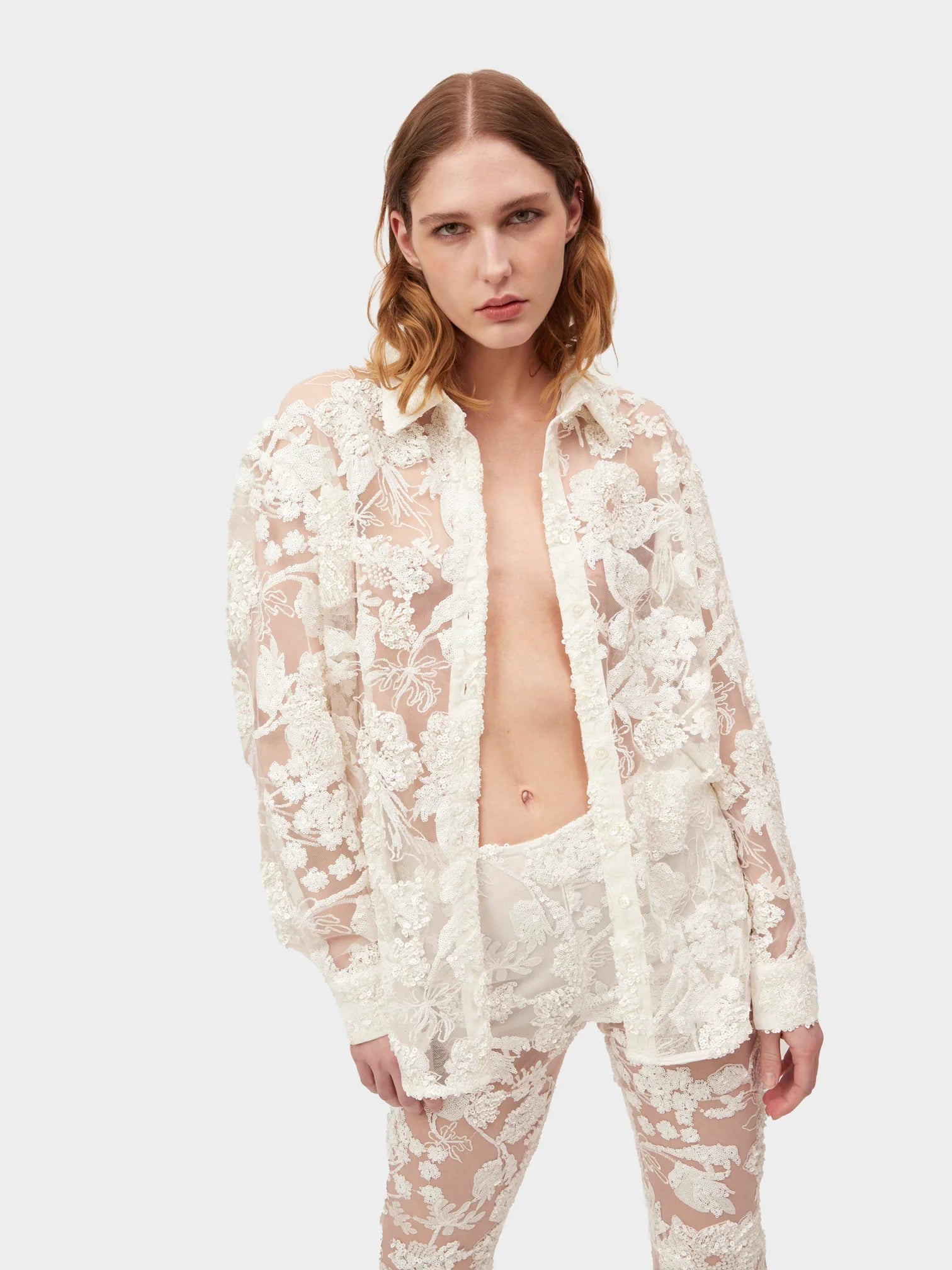 Introducing the Cara Set, a button-up style shirt crafted from exquisite sequin embroidered tulle, designed exclusively by AKNVAS. Elevate your wardrobe with this luxurious piece that combines sophistication and artistry. Perfect for any occasion, this shirt exudes style and exclusivity.