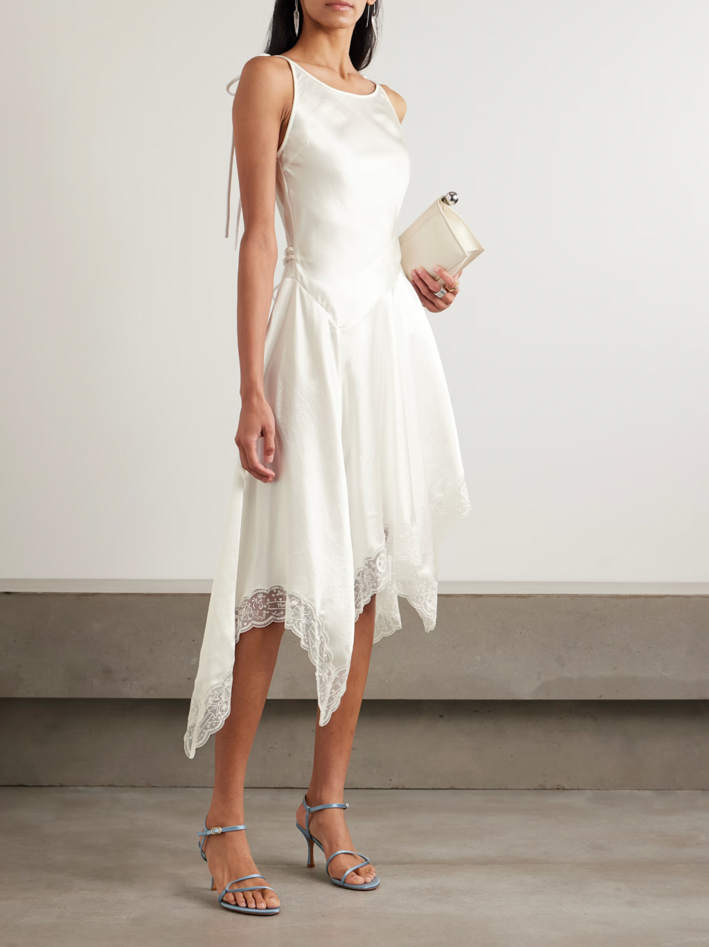 Cut on the bias from luminous white satin with a subtle hammered finish, the Doyla Hammered-satin Midi Dress by Acne Studios exudes effortless elegance. Its adjustable straps and self-tie belt let you tailor the fit to highlight your waist, while the asymmetric hem trimmed with delicate lace adds a touch of feminine allure. Perfect for making a refined statement, this dress beautifully captures light and movement for standout sophistication.