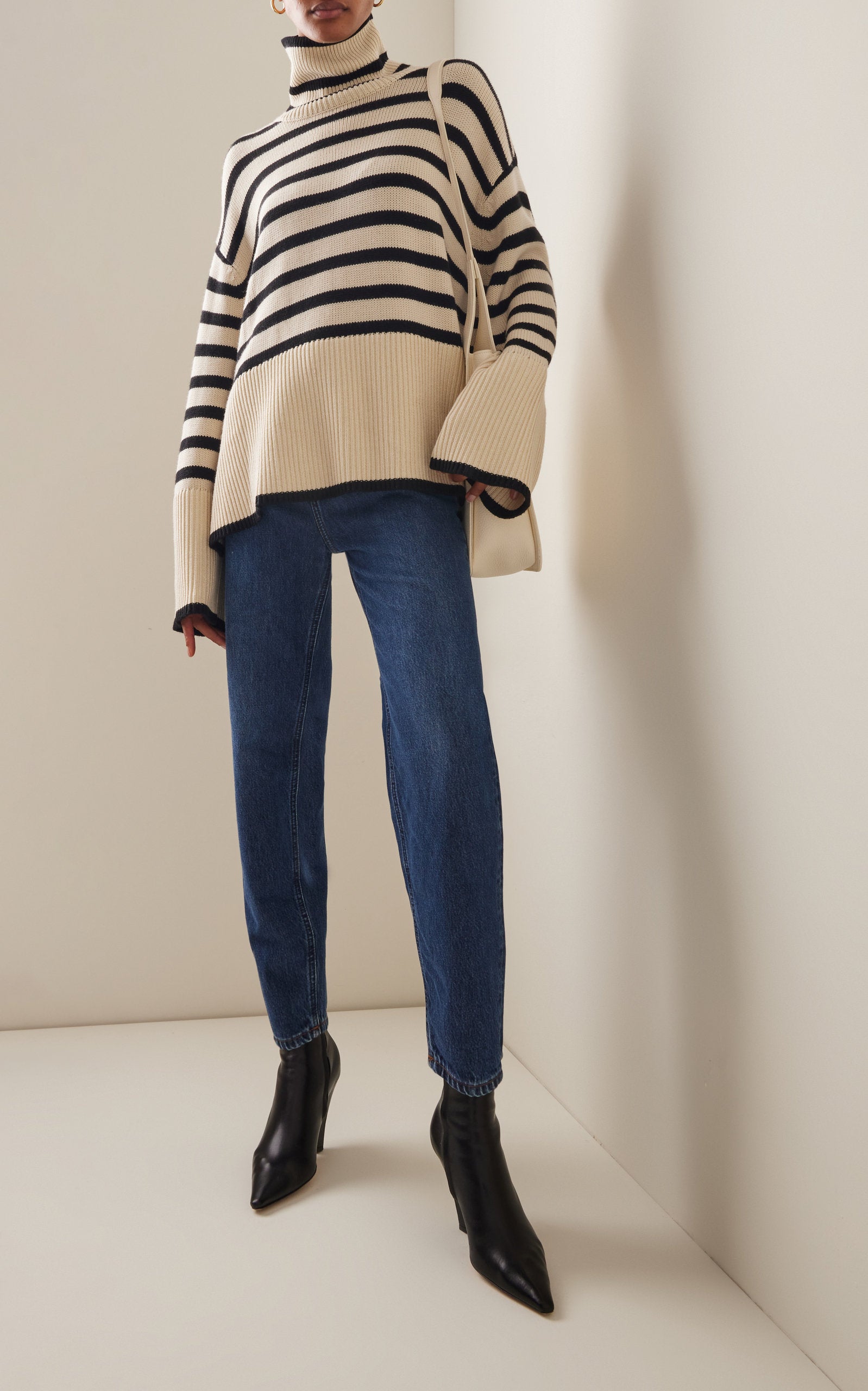 Elevate your wardrobe with the Signature Stripe Wool-Cotton Turtleneck Sweater by Totême. Blending cozy wool and breathable cotton, this sweater offers unmatched comfort and timeless style. Its clean lines and minimalist design reflect Stockholm's refined aesthetic, making it a versatile staple perfect for effortless layering. Inspired by vintage classics, this turtleneck channels modern Scandi-cool, providing a chic, everyday uniform that stands out with subtle sophistication.