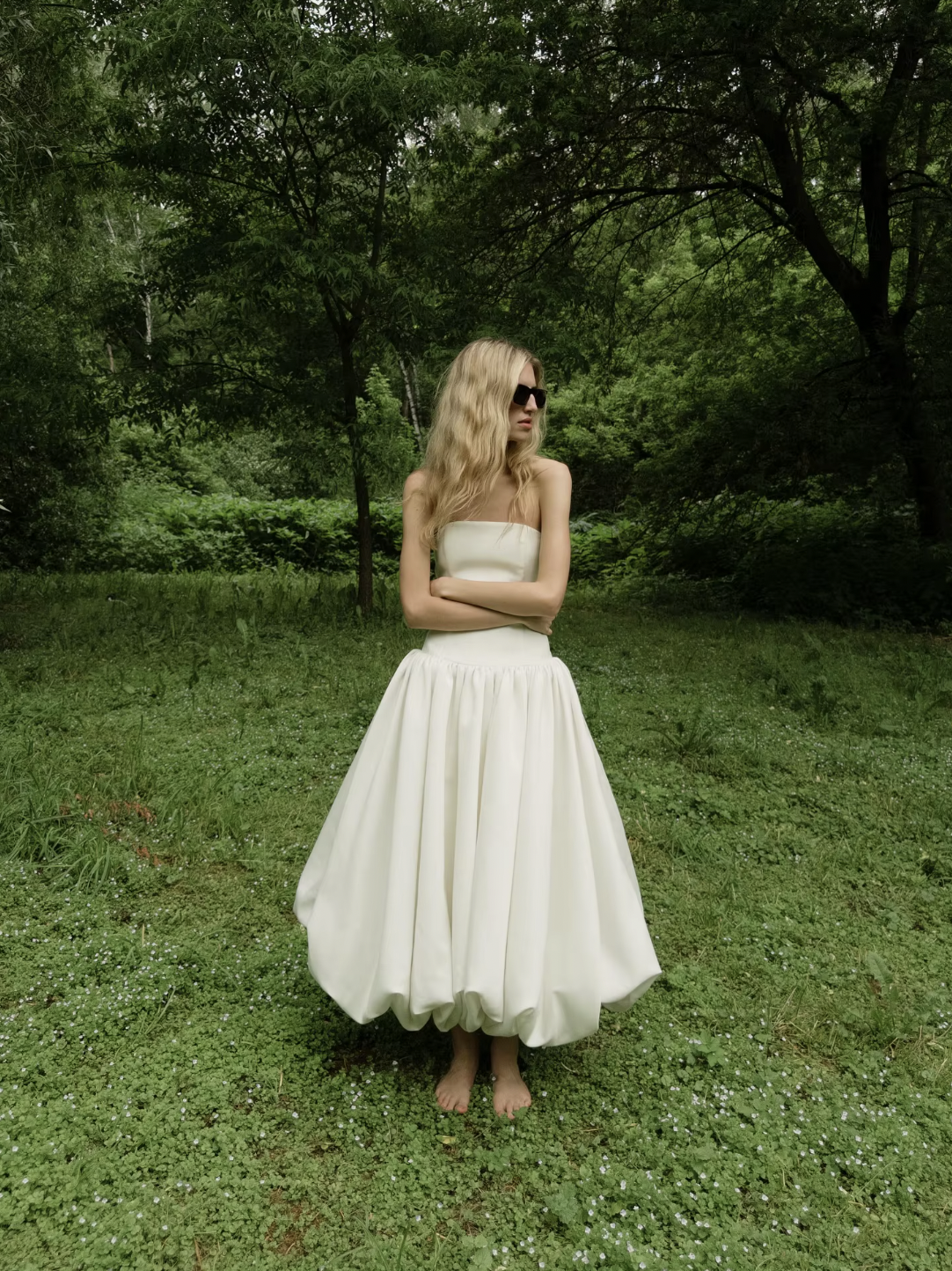 The Mayfair Dress offers timeless sophistication with a modern twist. Featuring a strapless, solid bodice and a flattering A-line silhouette, it highlights your figure with a high waist and pleated skirt that flows elegantly. Perfect for summer events and upscale parties, this sleeveless dress ensures comfort while exuding effortless grace, making it the ideal choice for warm-weather style.