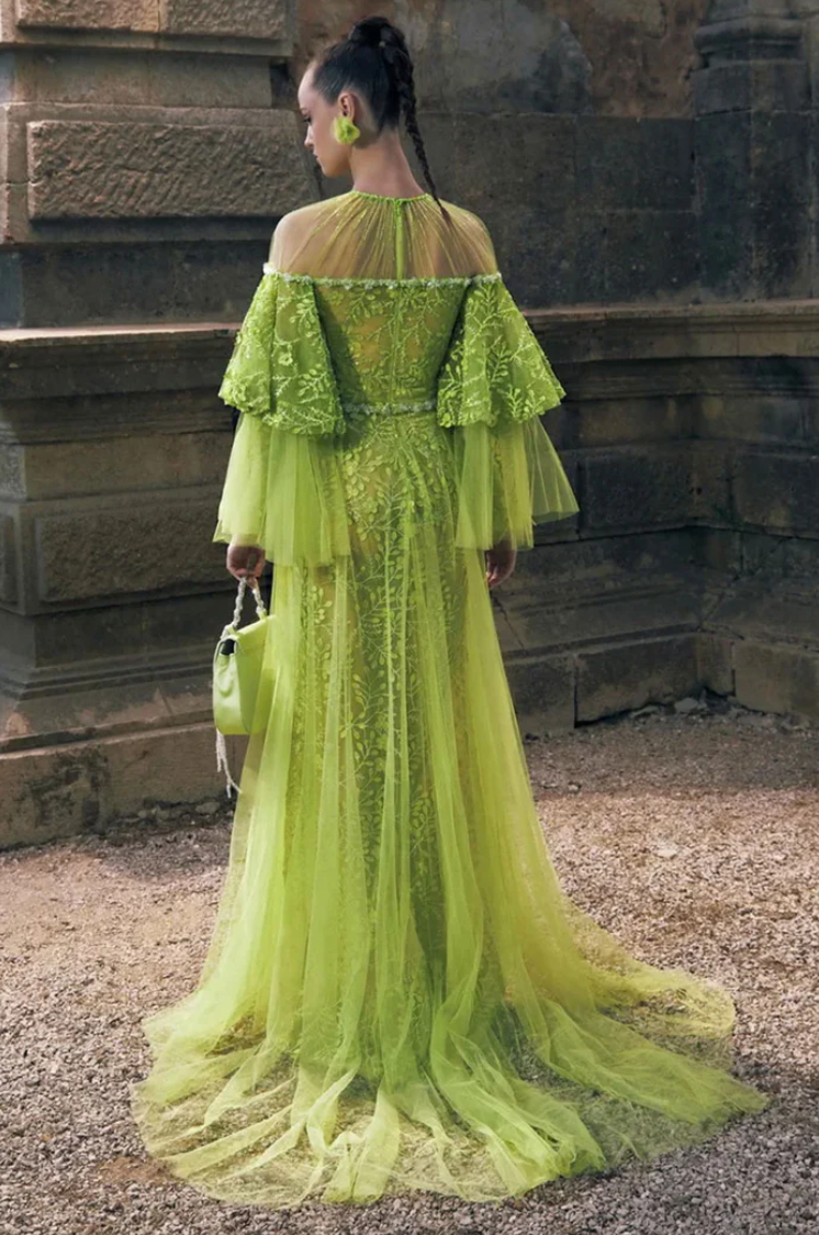 Indulge in luxury with the Nori Gown. Twirl and turn heads in this stunning layered gown boasting 3D embroidered lace, delicate beading, and dramatic ruffled long sleeves. Its flowy upper skirt and soft tulle add vibrancy and movement, while the jeweled rounded neckline and hidden back zipper/clasp exude sophistication.